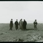 A group of well dressed men standing in a clifftop field during the salvage operation from the Eider. The plate has a J. Dore sticker on it. The Eider was carrying maize, cotton, gold, silver and mail when she ran aground on Atherfield Ledge on 31st January 1892. Salvage continued until 29th March when she was towed to Southampton