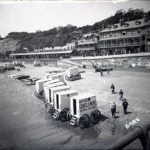 Sandown beach with beach huts and bathing huts viewed from the pier