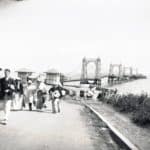 Group of people walking up the hill towards the camera with Seaview Pier in the background