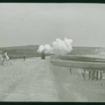 Ladies walking along Culver Parade as a gun is fired at Sandown Fort