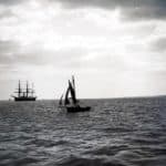 Barge and sailing ship in the Solent, one of the Solent forts can be seen in the background