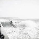 Waves crashing against the sea wall at Culver Parade, Sandown