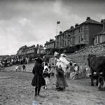 People and a horse on the beach at Sandown