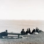 Group of people gathered on the shore watching Kaiser Wilhelm II reviewing the Fleet in Sandown Bay in 1889