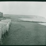 Culver Cliff viewed from Sandown, bathing huts can be seen in the foreground