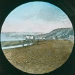 Colourised view of an engraving of Sandown with bathing huts and a horse visible