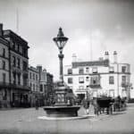 View of Ryde looking toward Royal Pier Hotel. Horse drawn vehicles in foreground