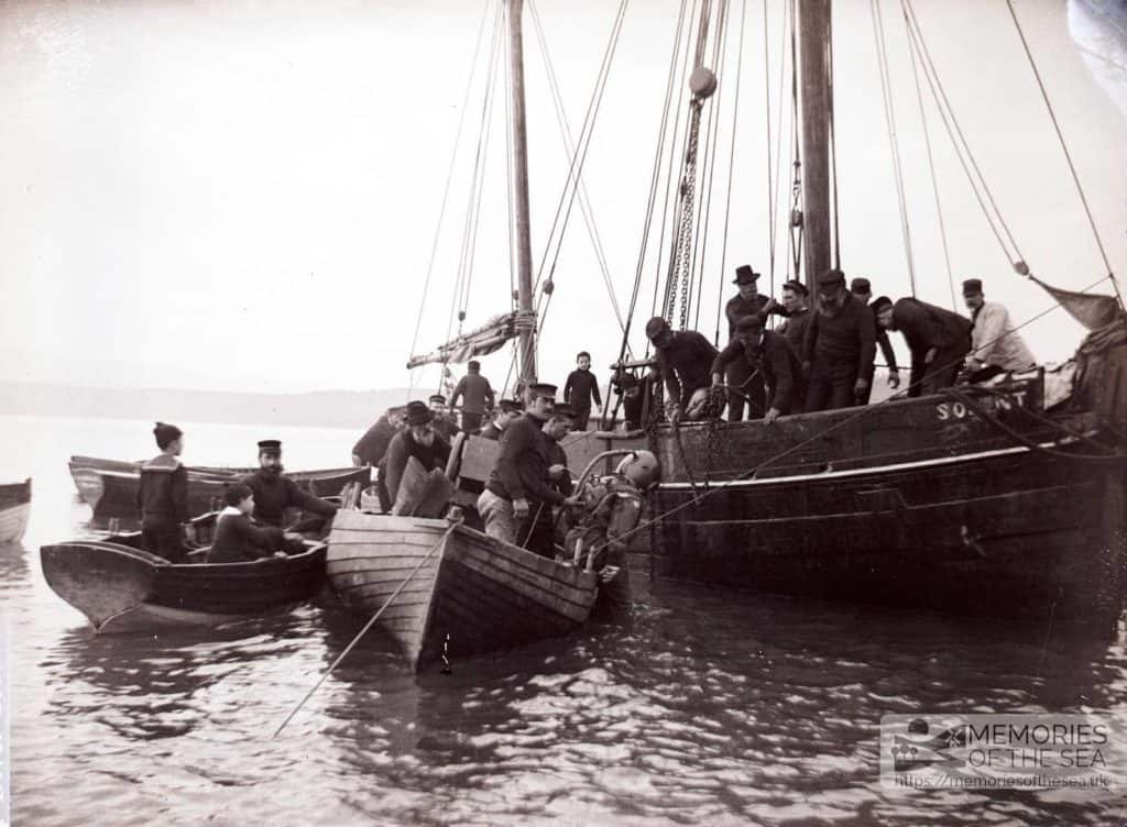 Diver descending into the sea, crew look on from a ship called The Solent