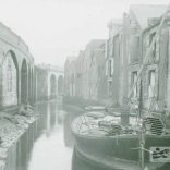 Barge in the foreground loaded with goods at Newport Quay