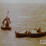 Trinity House work boat buoy jumpers on the buoy